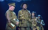 Gareth Radcliffe (Sergeant Thunder) and Ike Bennett (David Taylor) and ensemble in War Horse. c. Brinkhoff-Moegenburg