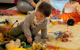 Sensory workshop toddler (boy) playing with sensory materials