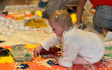 Sensory workshop toddler (girl) playing with sensory materials