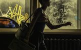 Iris Kelly (Shoko Ito) walking past a dance classroom window. Credit: Johan Persson