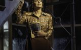 Miss Sherman (Shanay Holmes) holding a comic book and singing emotionally in a classroom. Credit: Johan Persson